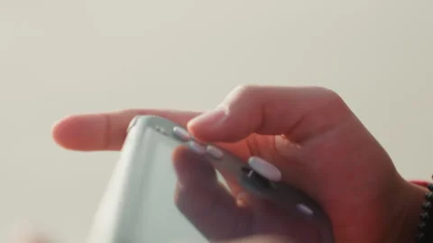 Close examination of thumb adjusting gaming controller settings. Precise hand Stock Footage 338444648
