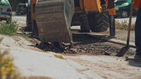 Close up of excavator breaking asphalt. Removing layer of old damaged asphalt Stock Footage 242174672