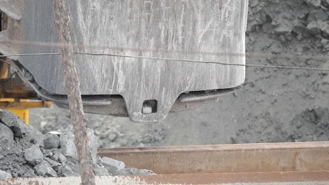 Close-up of excavator bucket loading ore in the dump-body truck. Mining industry Stock Footage 99889353