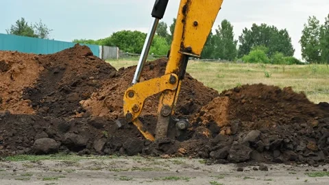 Close up of an excavator digging a deep trench Stock Footage 157833756