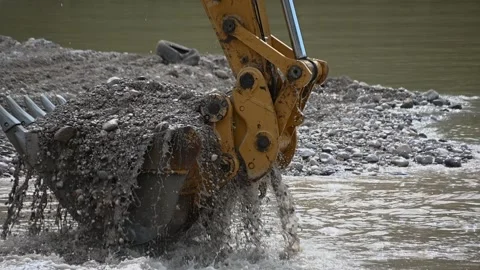 Close up excavator digging sand pebbles from the river Stock Footage 135961877