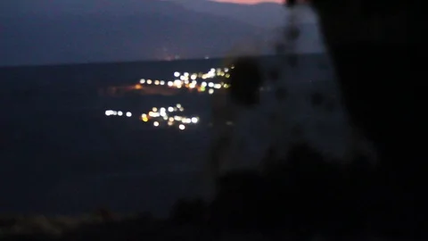 Close up of an excavator operating at night with lights in the backdrop Stock Footage 121405423