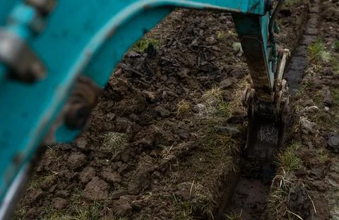 Close up of excavator or digger digging some a soil or clay, industrial concept Stock Photos