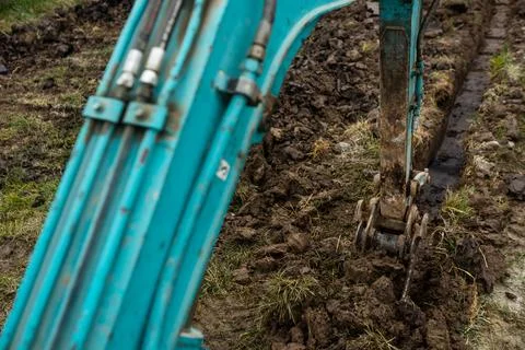 Close up of excavator or digger digging some a soil or clay, industrial concept 库存照片