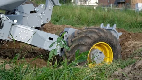 Close up of excavator’s wheels while moving in the ground Stock Footage 77209653