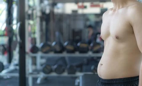 Close up the excessive fat belly. Man overweight abdomen. Man diet lifestyle  Stock Photos