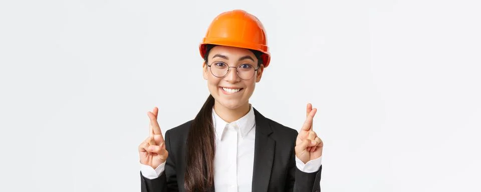 Close-up of excited hopeful asian female engineer, construction manager in Stock Photos