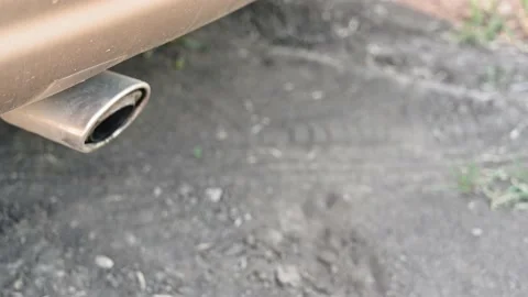 Close-up of the exhaust pipe of a working yellow car. Car muffler makes a sound 库存影片 158181137