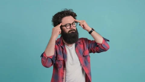 Close up of an exhausted man, suffering from a headache holding his hands behind Stock Footage 144385135
