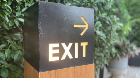 Close-up of an exit sign with an arrow Stock Footage 311503357