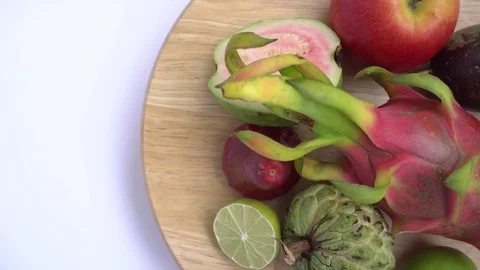 Close up of exotic fruit: Halved passion, dragon, annona, custard apple, guava Stock Footage 76601743