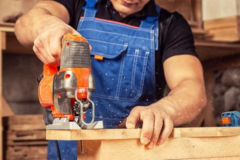 Close up of experienced carpenter in work clothes and small buiness owner  ca Stock Photos
