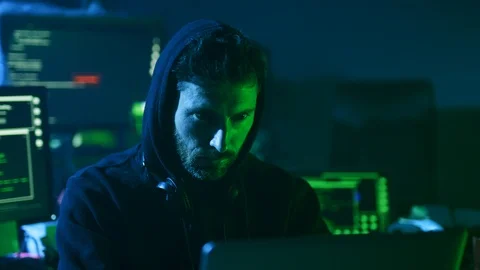 Close-up of experienced computer hacker at work. Portrait of concentrated young 動画素材 108823086