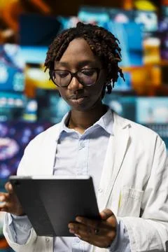 Close up of expert doing scientific research, analyzing virus data on tablet Stock Photos