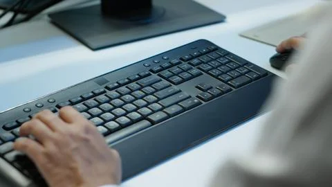 Close up of expert typing on keyboard in server room, coding on computer Stock Photos