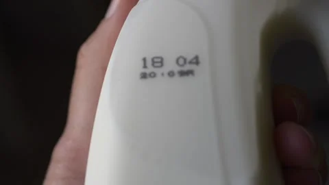 Close-up of expiration date printed on milk packaging, highlighting importance Video stock 332837638