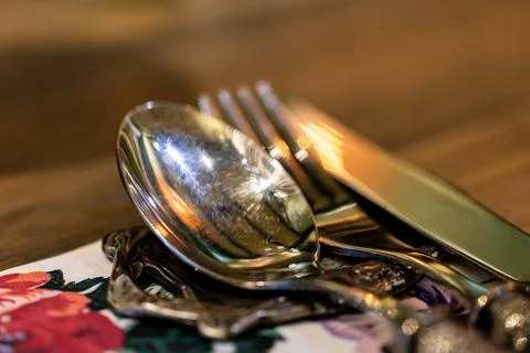 Close-up of exquisite silverware in an elegant restaurant. Stock Photos
