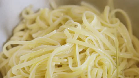 Close up of extra virgin olive oil being poured over spaghetti. Stock Footage 274070048