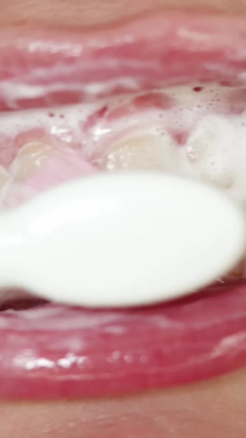 Close-up extreme macro shot of brushing teeth with foam and toothbrush Stockbeeldmateriaal 343838152
