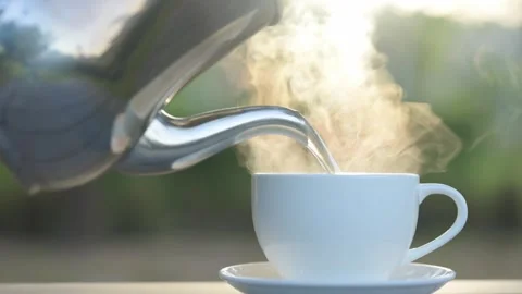 Close-up of extremely hot water being poured into a coffee mug outdoors Stock Footage 294795093