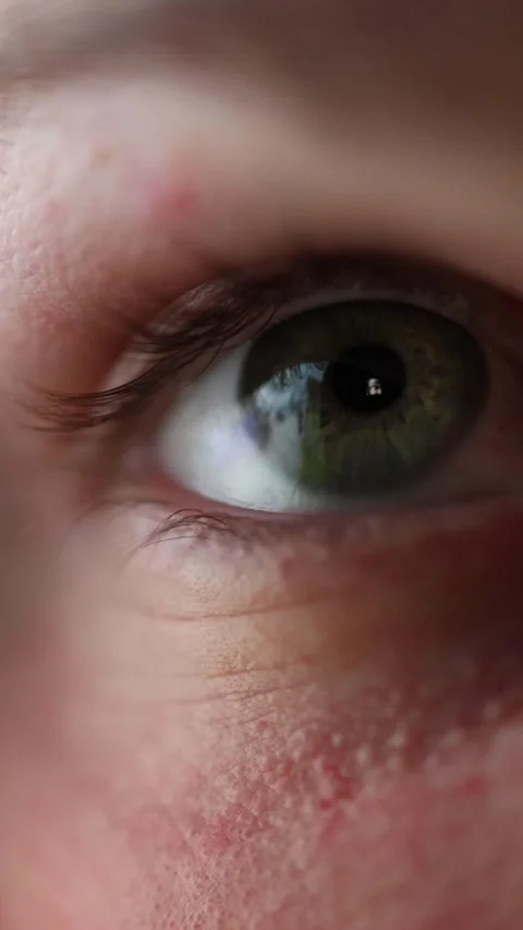 Close up eye absorbed in online content Stock Footage 329756144