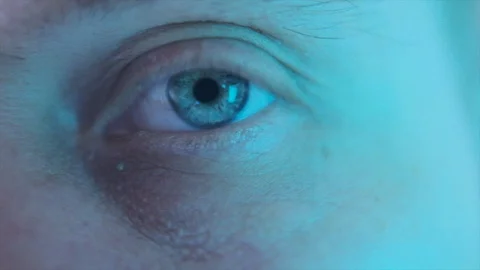 Close-up eye with color changing light Stock Footage 128576406
