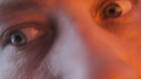 Close-up eye with color changing light Stock Footage 128576561