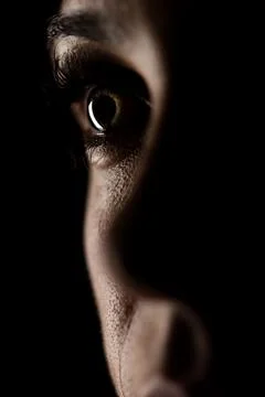 Close-up of an Eye in Dramatic Lighting Against a Dark Background Stock Photos
