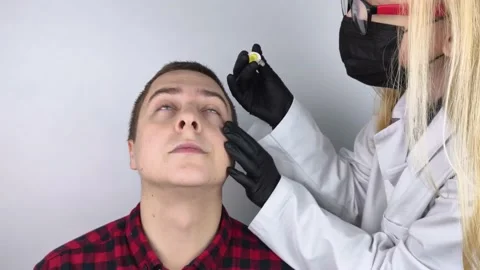 Close-up of eye drops. A man at the doctor appointment, who drips drops into the Stock Footage 166672013