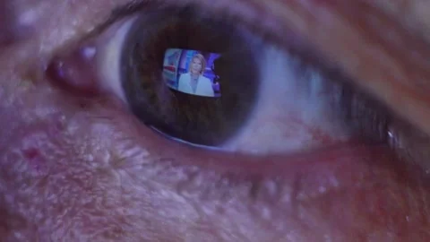 Close-up eye of an elderly man watching the news 動画素材 133760003