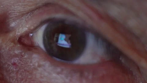 Close-up eye of an elderly man watching the news 動画素材 134464168