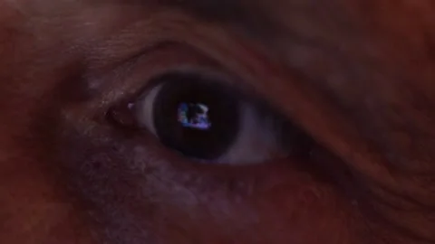 Close-up eye of an elderly man watching the news Stock Footage 138137259