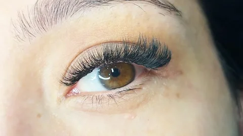 Close up of eye with eyelash extensions ,beauty salon treatment ,2d volume, 3d v Stock Footage 317742915
