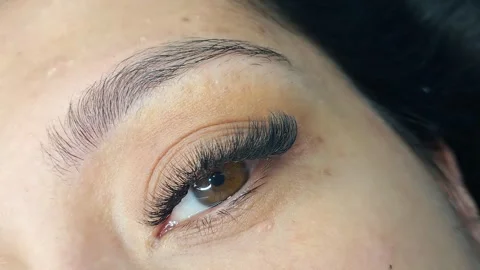 Close up of eye with eyelash extensions ,beauty salon treatment ,2d volume, 3d v Stock Footage 317742918