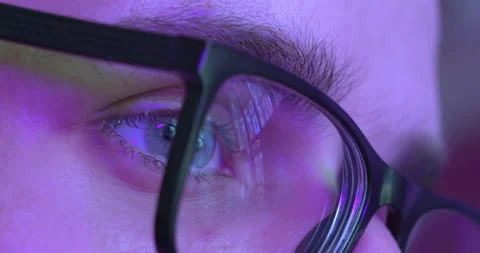 Close-Up Of Eye In Glasses Reflecting Computer Screen In Blue Light Stock Footage 223976009