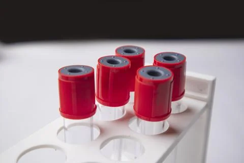 Close-up, eye-level shot of four empty medical blood collection tubes with .. Stock Photos