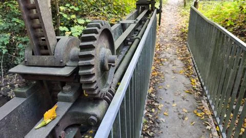 A close-up, eye-level shot of an old, rusty industrial gear mechanism, likely Stock Photos