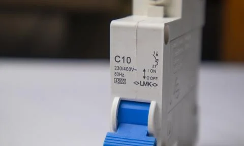 Close-up, eye-level shot of a white C10 miniature circuit breaker, focusing.. Stock Photos