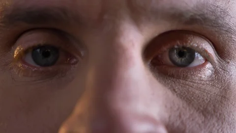 Close-up eye-portrait of middle-aged caucasian man watching calmly and directly Stock-Footage 100289629