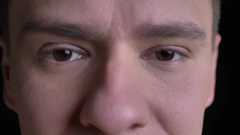 Close-up eye-portrait of middle-aged caucasian man watching seriously into Video stock 104803800