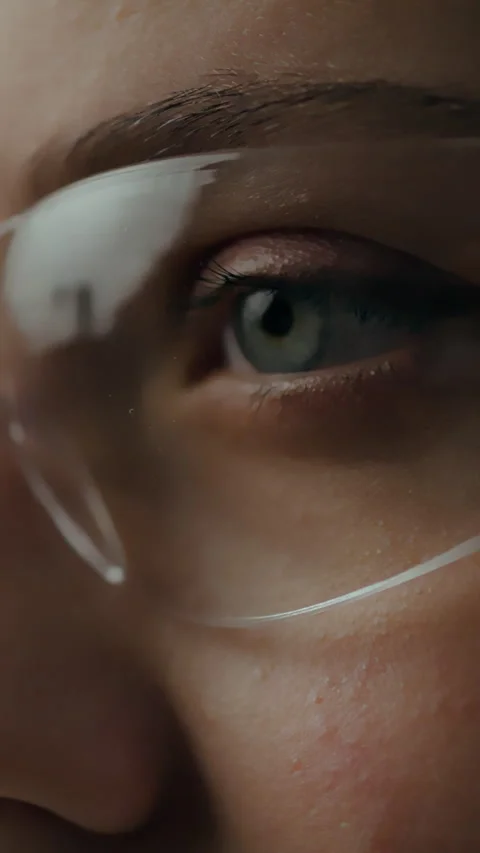 Close-up of an eye wearing protective glasses during a scientific experiment Stock Footage 331538851