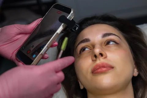 Close up of eyebrow before permanent makeup procedure, specialist documenting Stock Photos