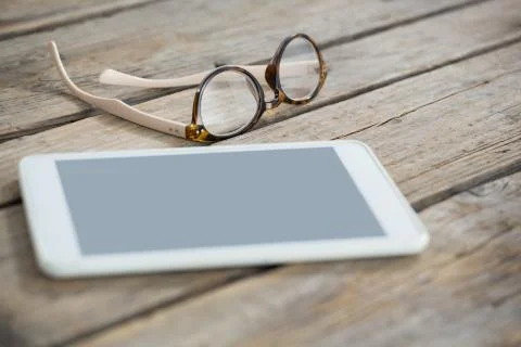 Close up of eyeglasses and tablet computer on table 写真素材