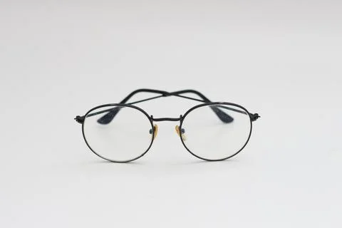A close up of eyeglasses with black frames isolated on white background Stock Photos
