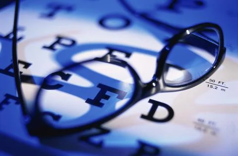 Close up of eyeglasses on an eye chart Foto stock