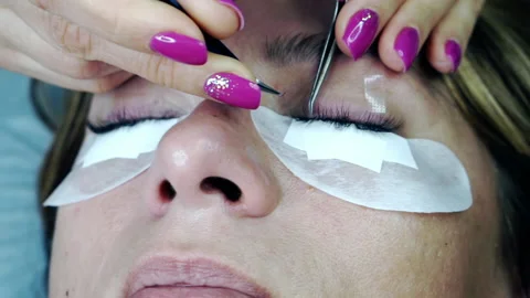 Close-up of the eyelash extension process. Stock Footage 163377053
