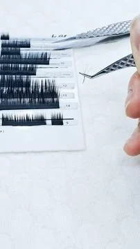 Close up of eyelash extensions and professional tools for application. Stock Photos