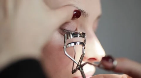 Close-up of an eyelashes curler in use. Professional make-up Stock Footage 54635649