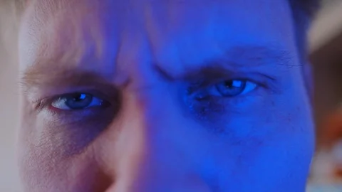 Close-up eyes with color-changing light, great surprise Stock Footage 128576796