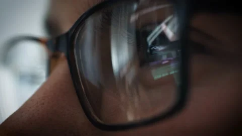 Close up of eyes with glasses looking at a computer Stock Footage 132707269